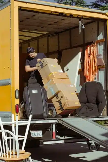 Movers unloading boxes from a moving truck