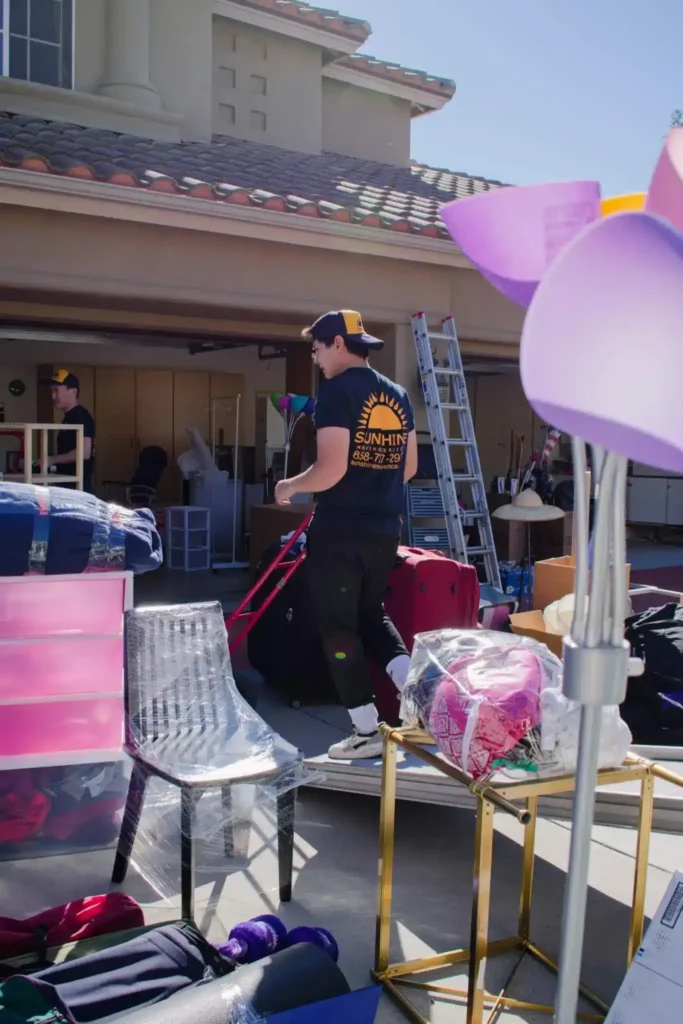 Movers loading a Sunshine Moving Services truck